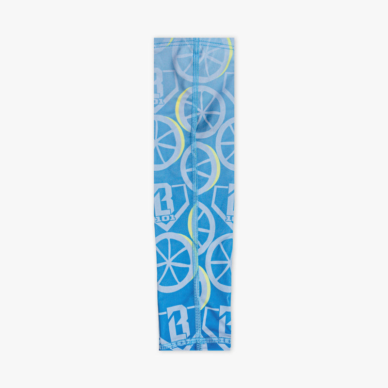 Youth model wearing blue youth arm sleeve with "Lemonade Splash" design