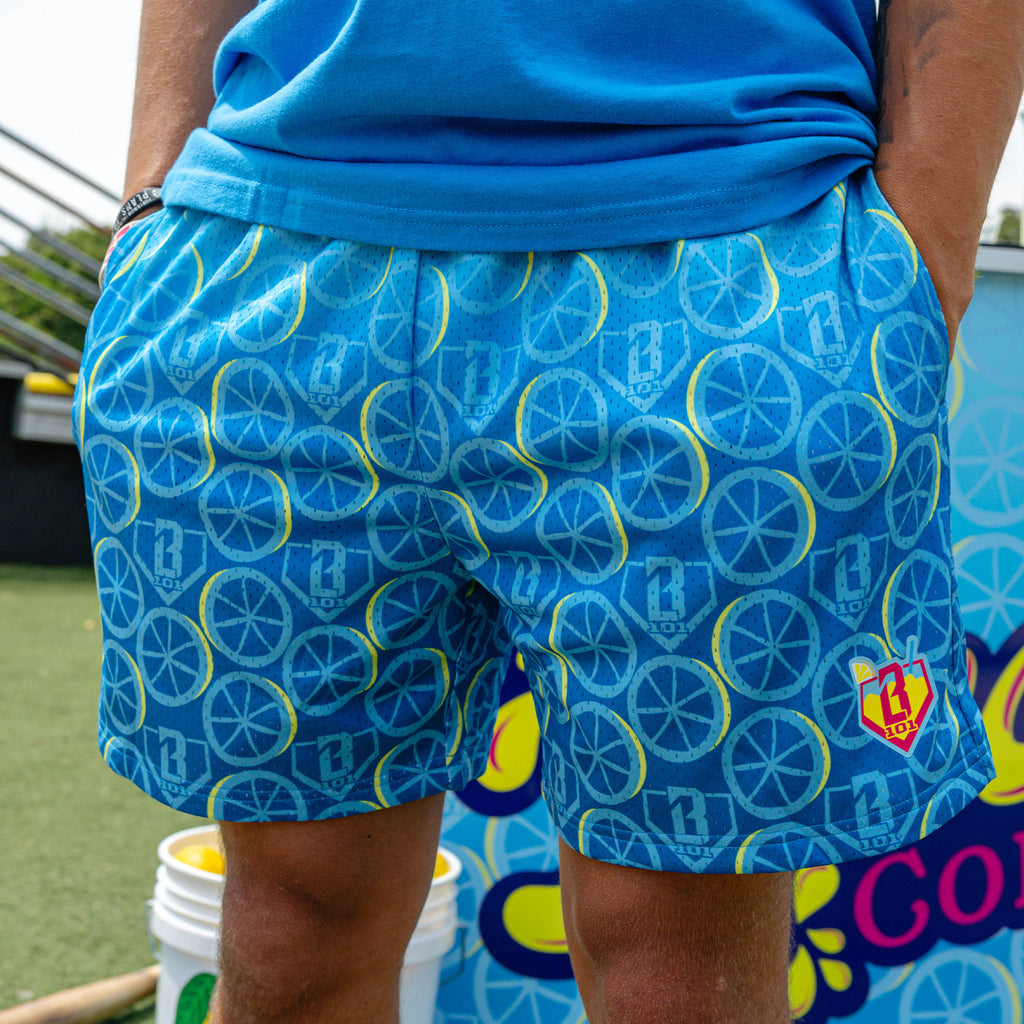 Adult model wearing blue shorts with "Lemonade Splash" design