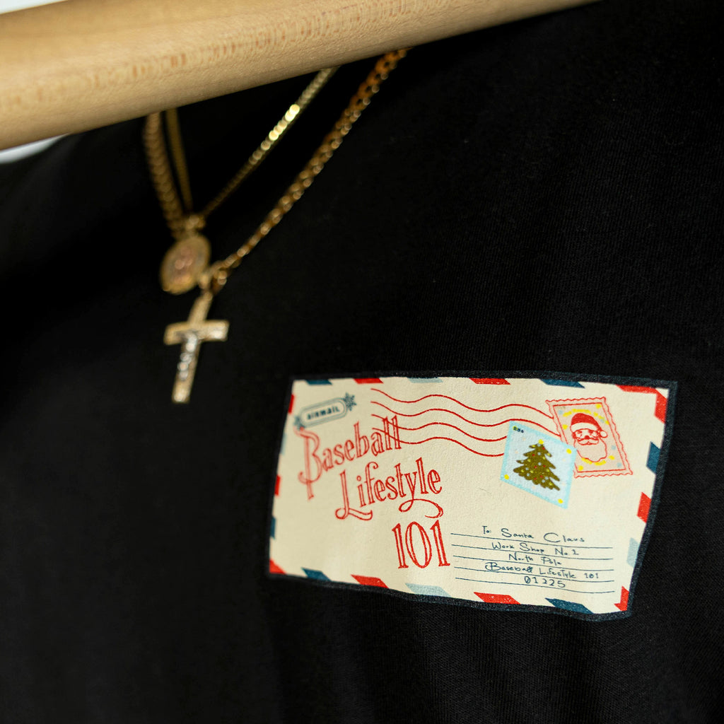 Adult model wearing black graphic tee with "Letter To Santa" design