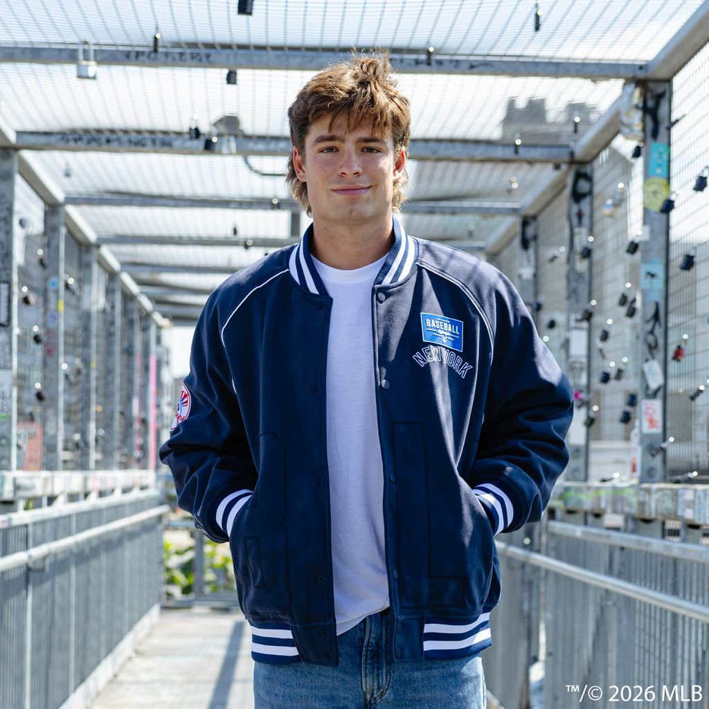 Adult model wearing navy New York Yankees Stadium bomber jacket