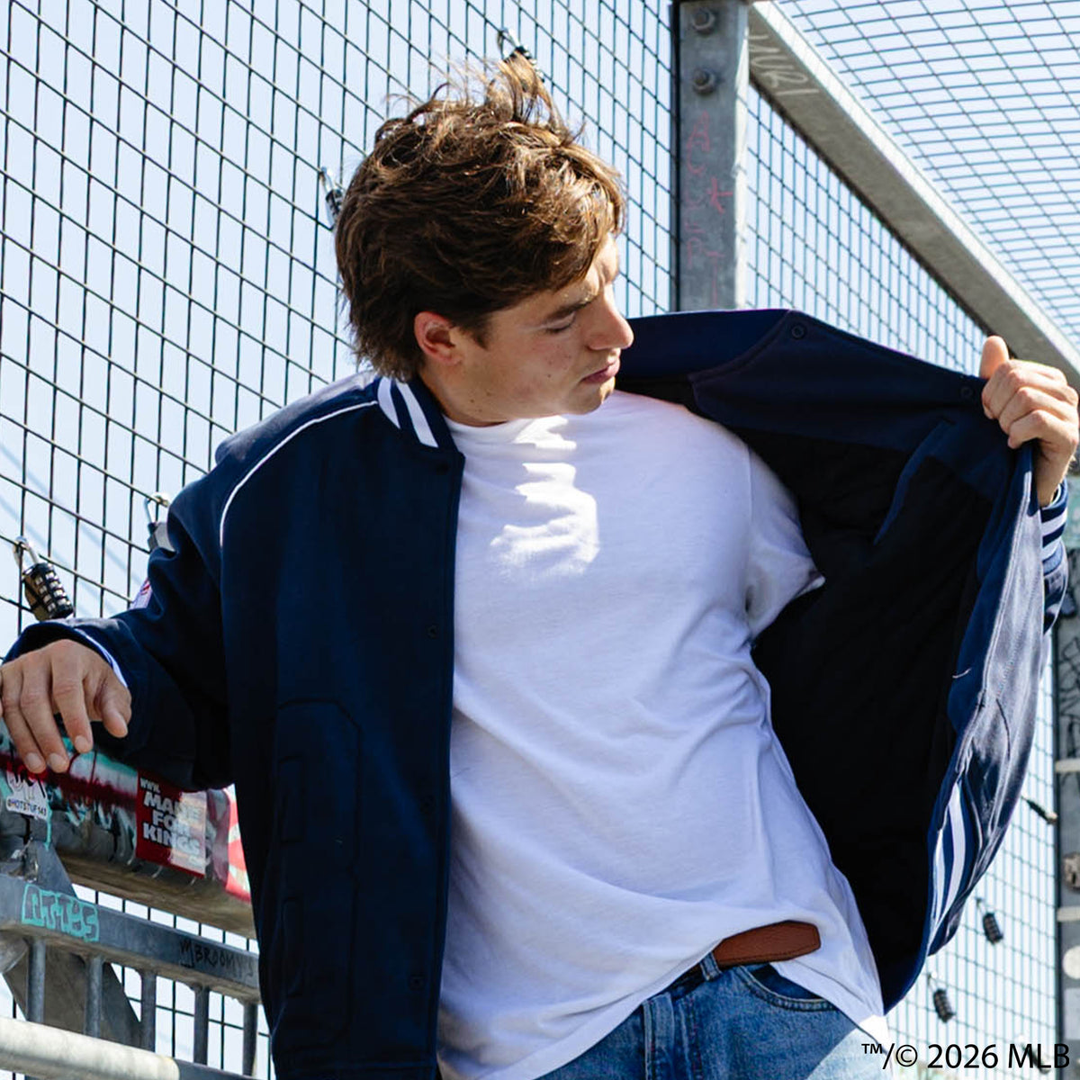 Adult model wearing navy New York Yankees Stadium bomber jacket