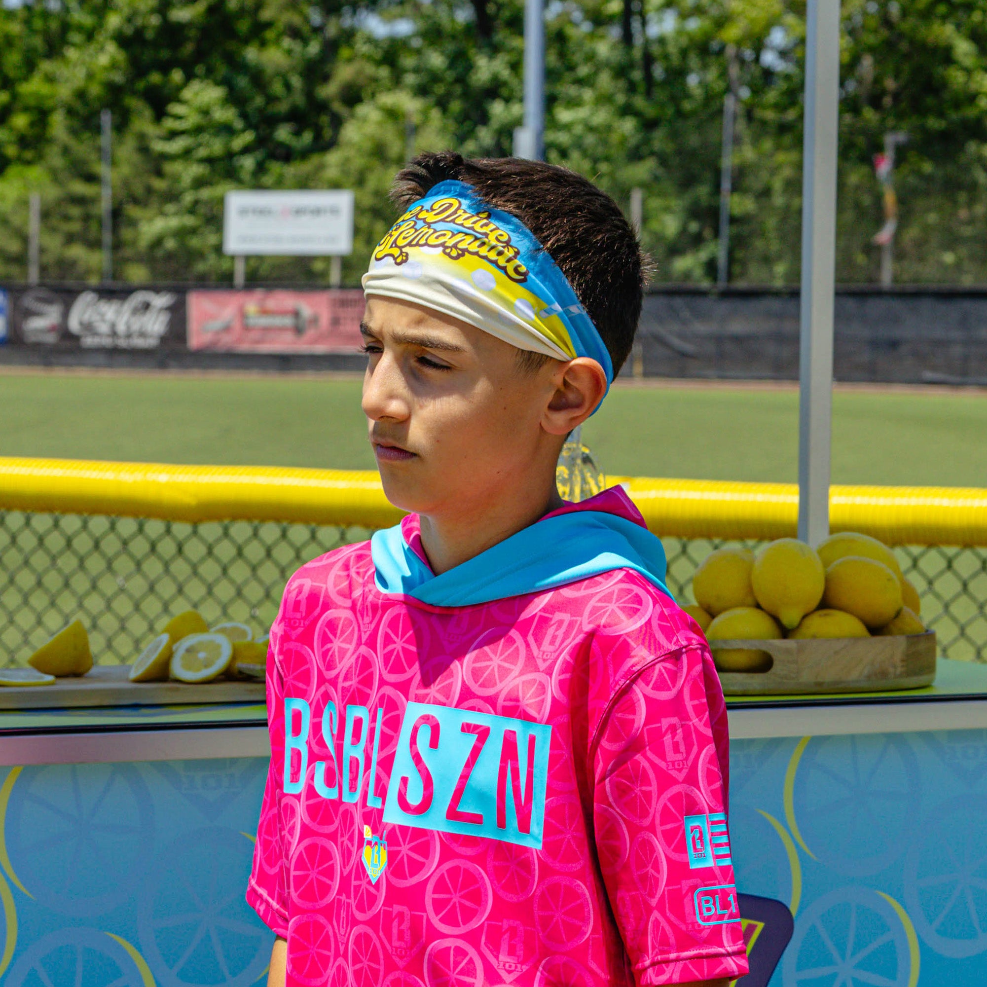 Adult model wearing blue headband with "Lemonade" design