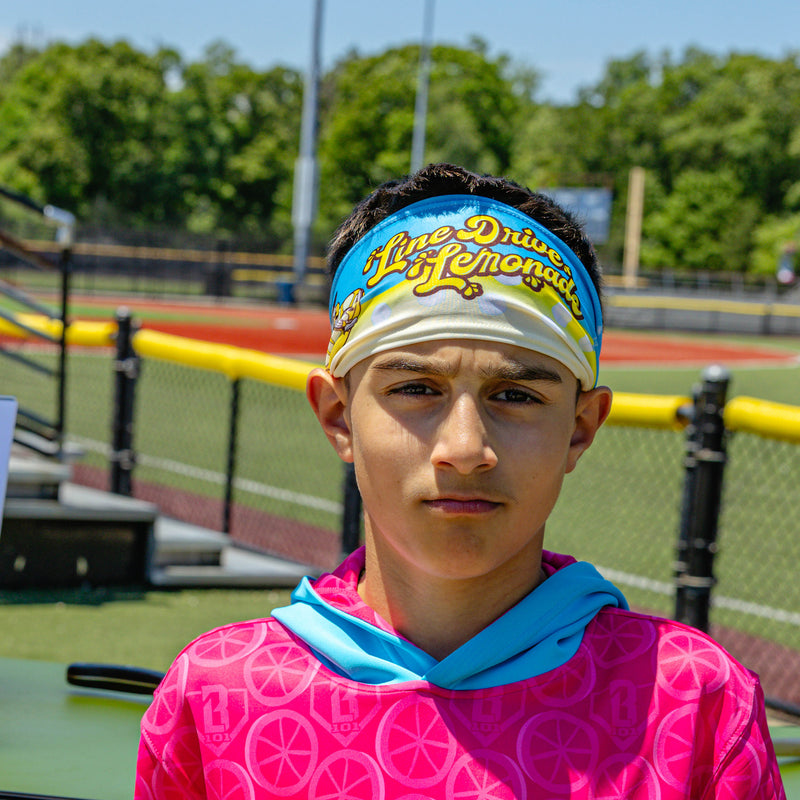 Adult model wearing blue headband with "Lemonade" design