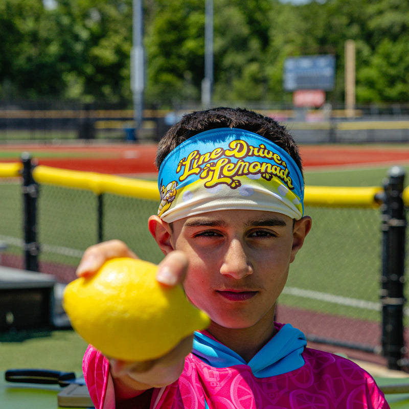 Adult model wearing blue headband with "Lemonade" design