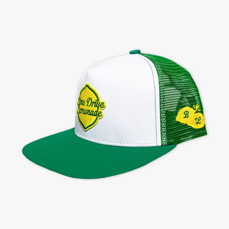 Adult model wearing green hat with "Line Drive Off Field" design