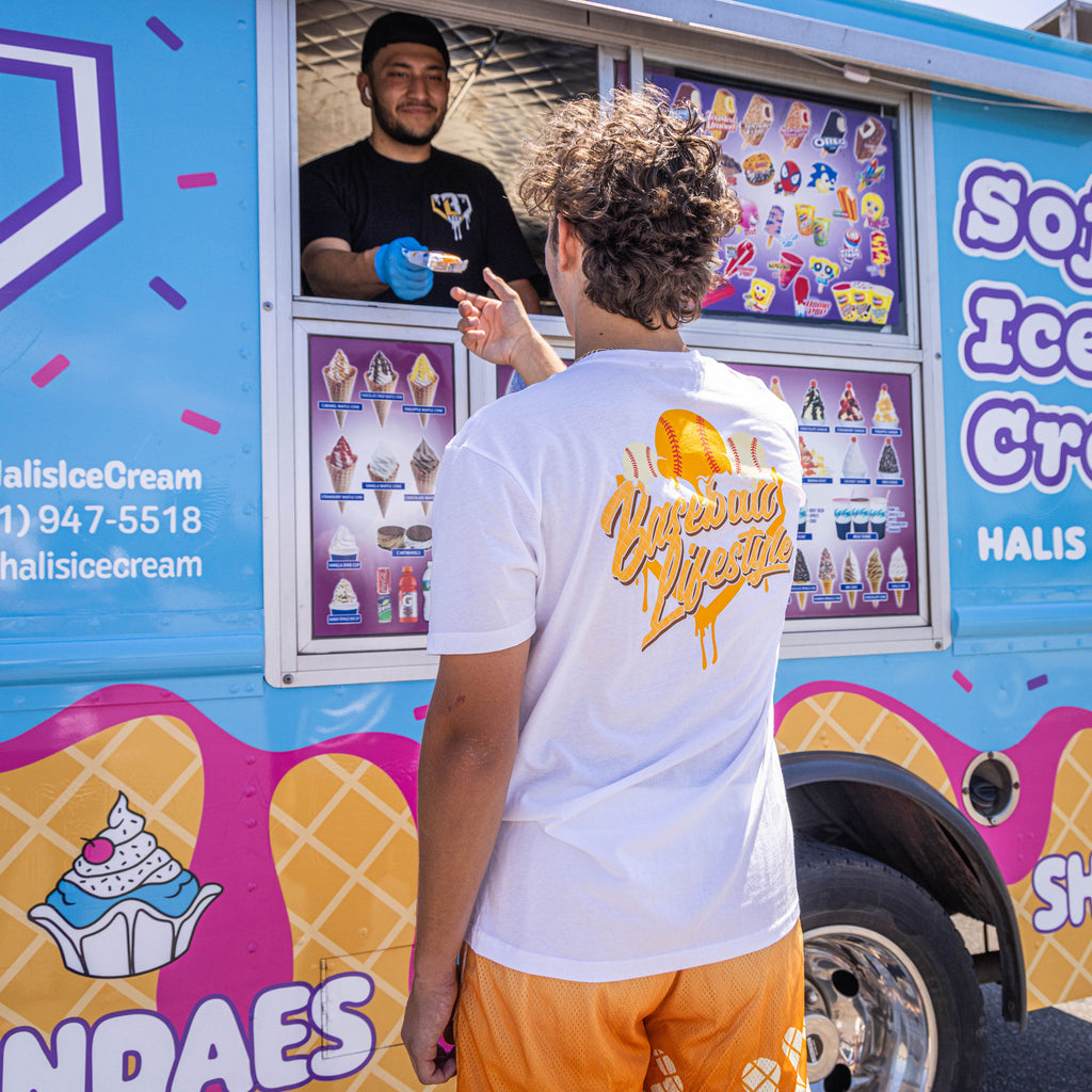 Adult model wearing white Ice Cream Creamsicle graphic tee