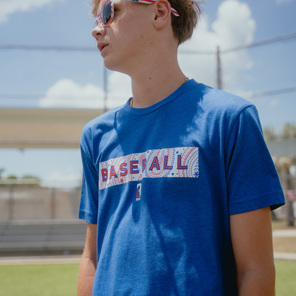 Youth model wearing blue Paisley Liberty youth graphic tee