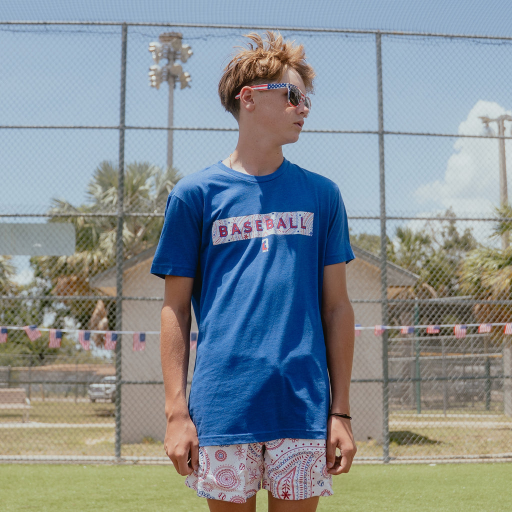 Youth model wearing blue Paisley Liberty youth graphic tee