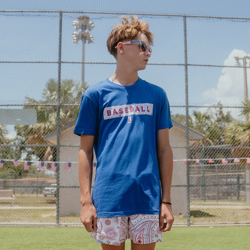 Youth model wearing blue Paisley Liberty youth graphic tee