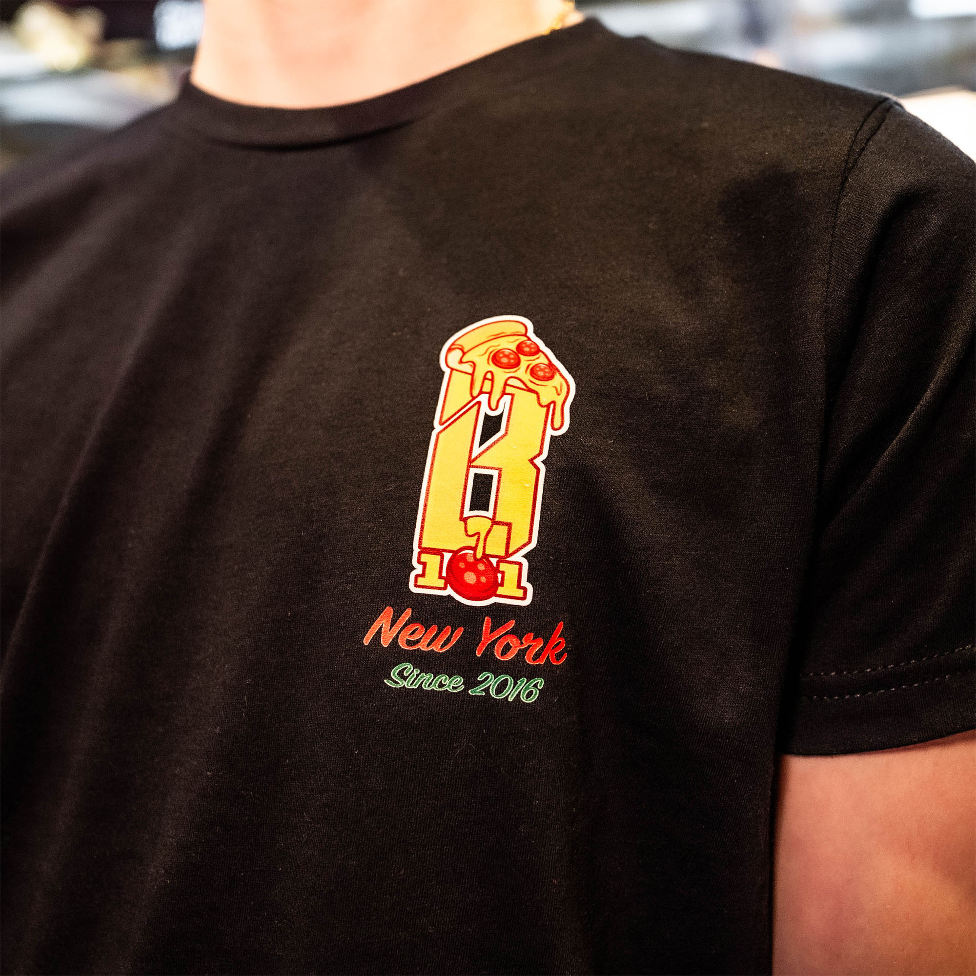 Adult model wearing graphic tee with “Pizza Guy” design