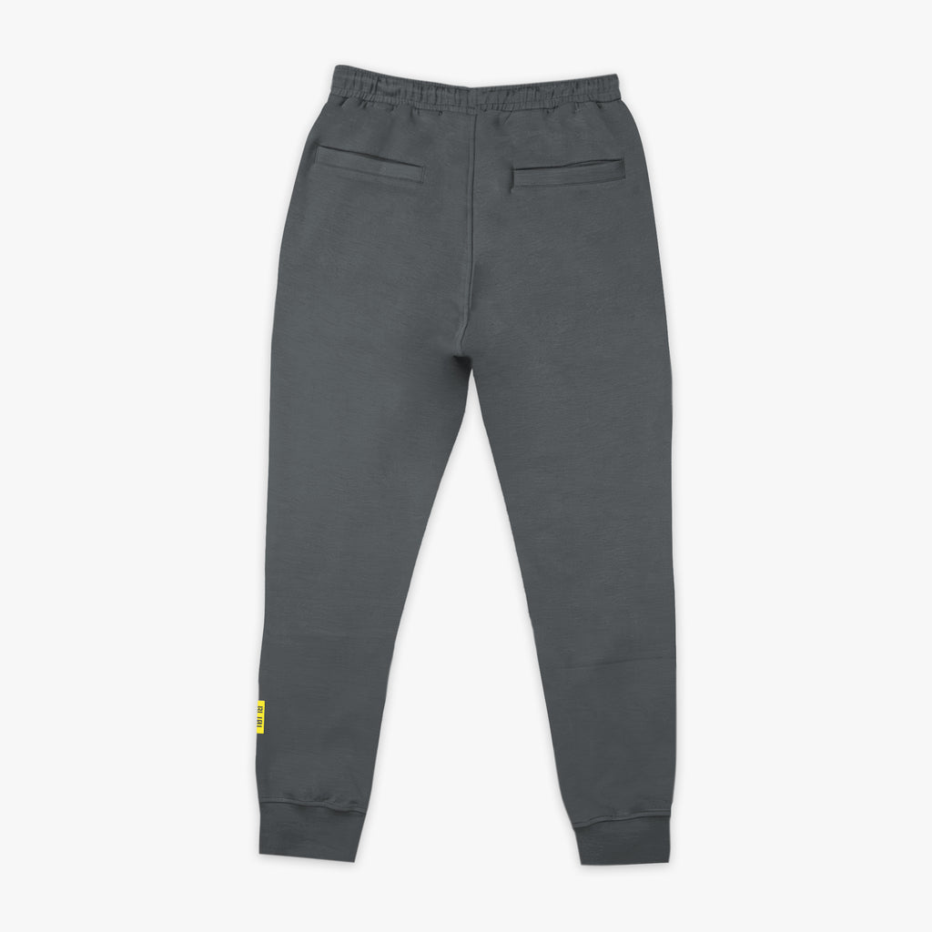 Gray sweatpants with a small yellow logo on a white background