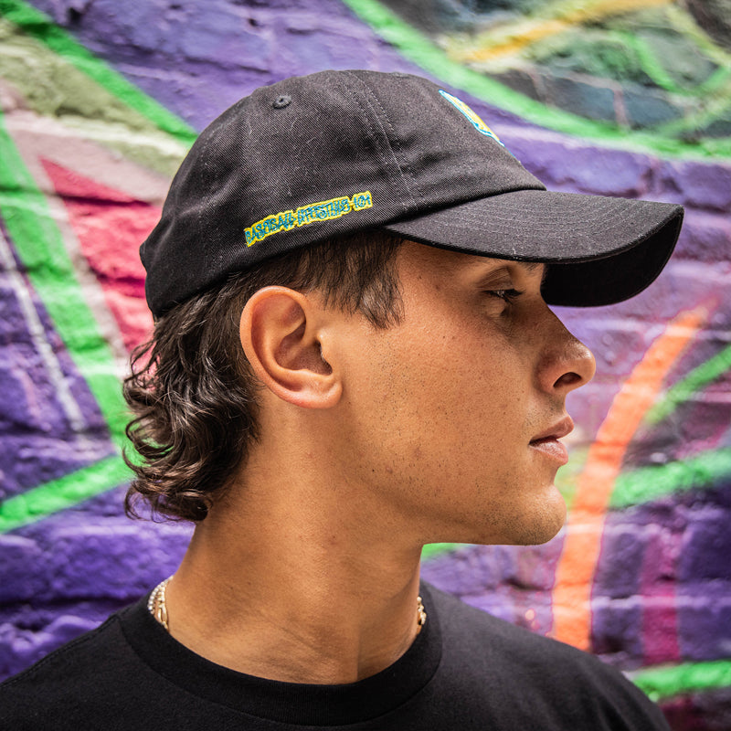 Person wearing a black cap with a blue and yellow Baseball Lifestyle 101 logo
