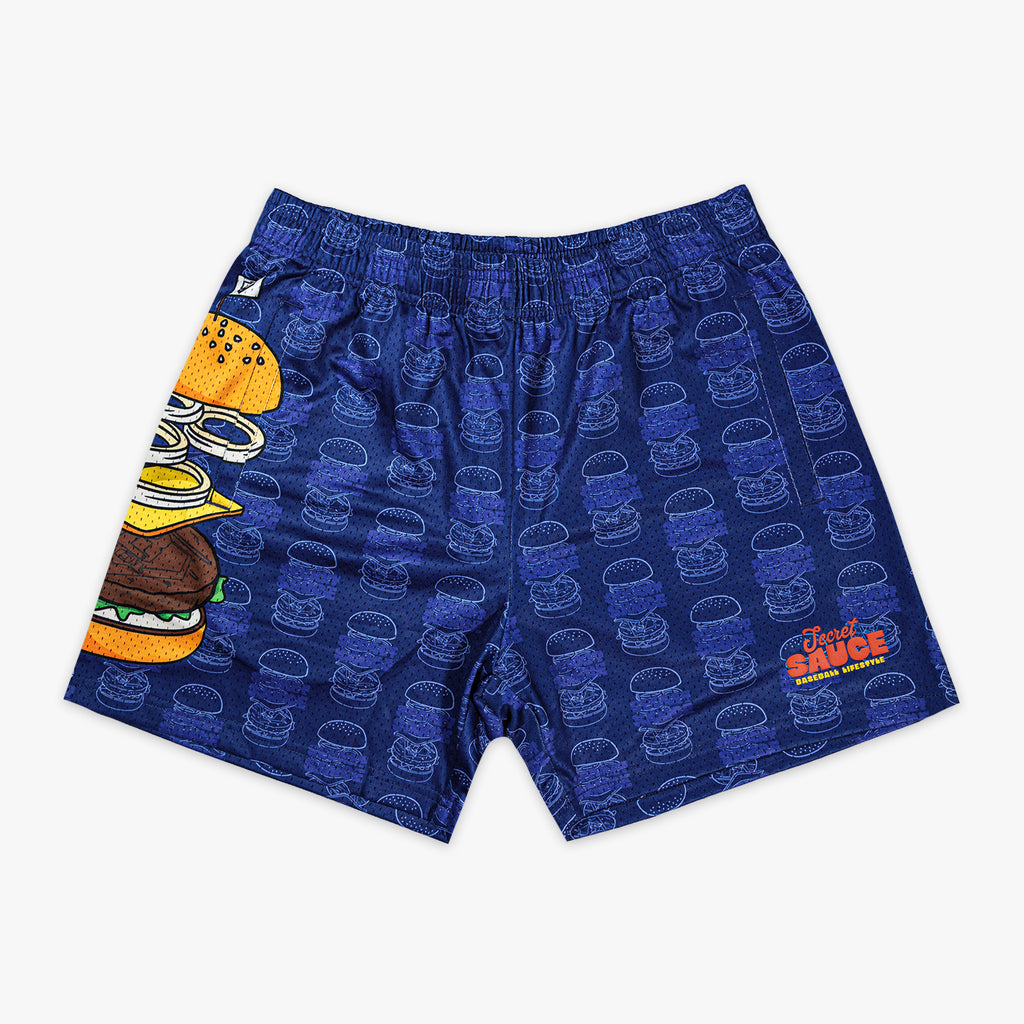 Blue mesh shorts with allover burger line art pattern large exploded burger graphic on left leg and Secret Sauce Baseball Lifestyle logo on right leg on white background