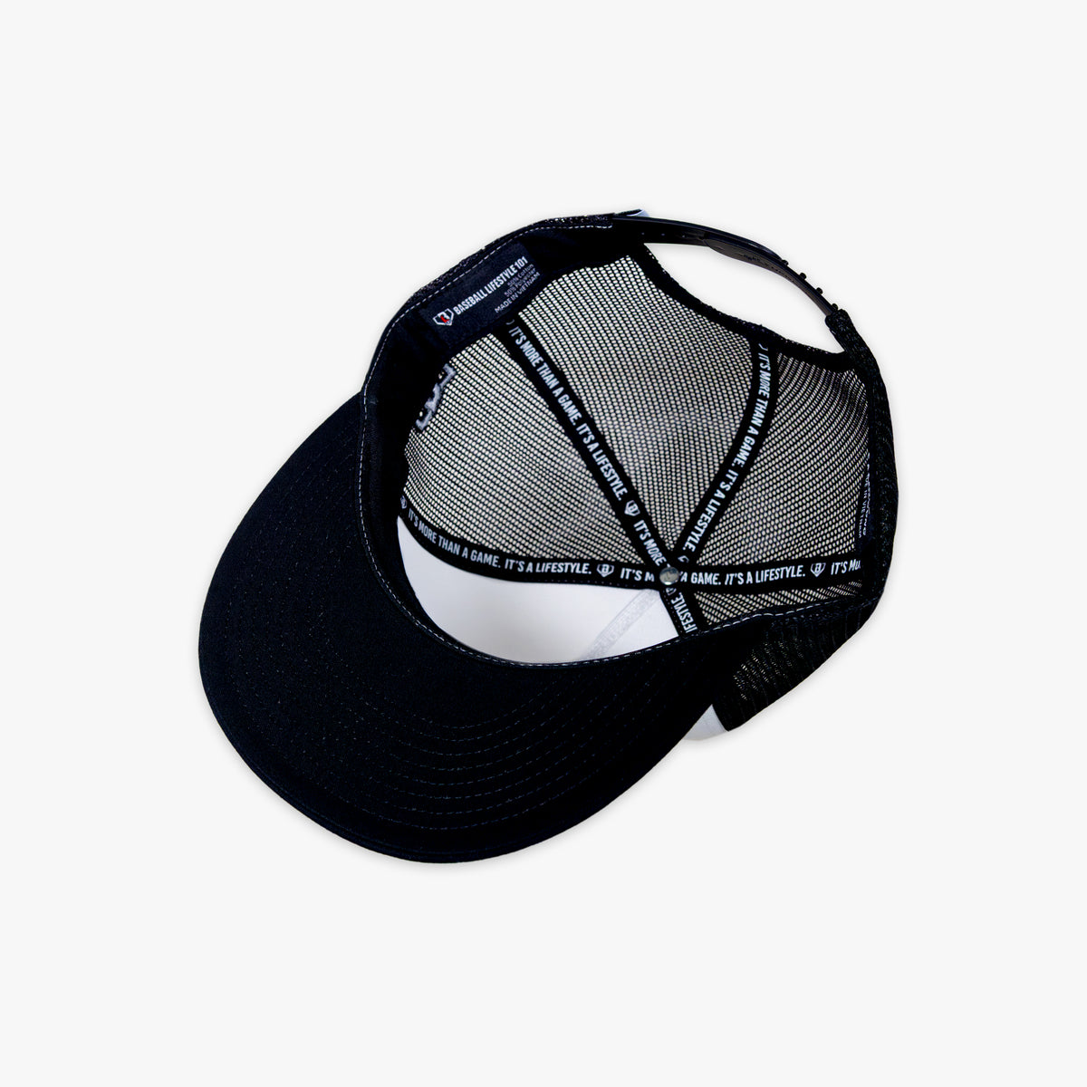 Black cap with white mesh back and Baseball Lifestyle tag on a white background
