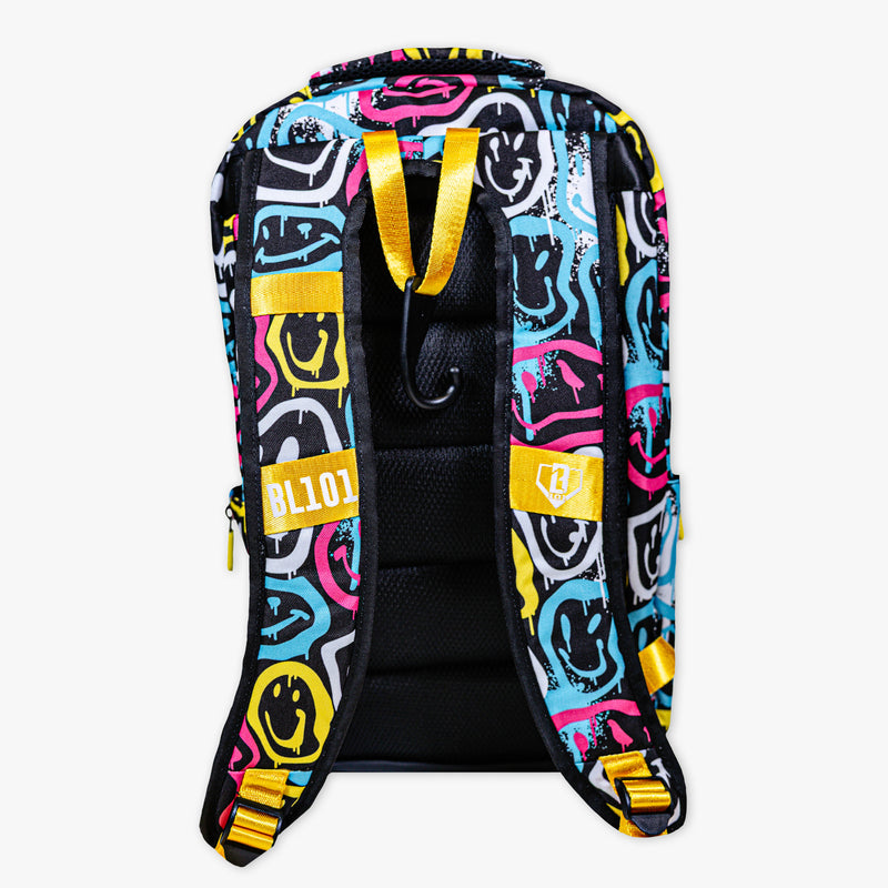 Adult model wearing multi-color backpack with "Smiley Slugger SZN 2" design