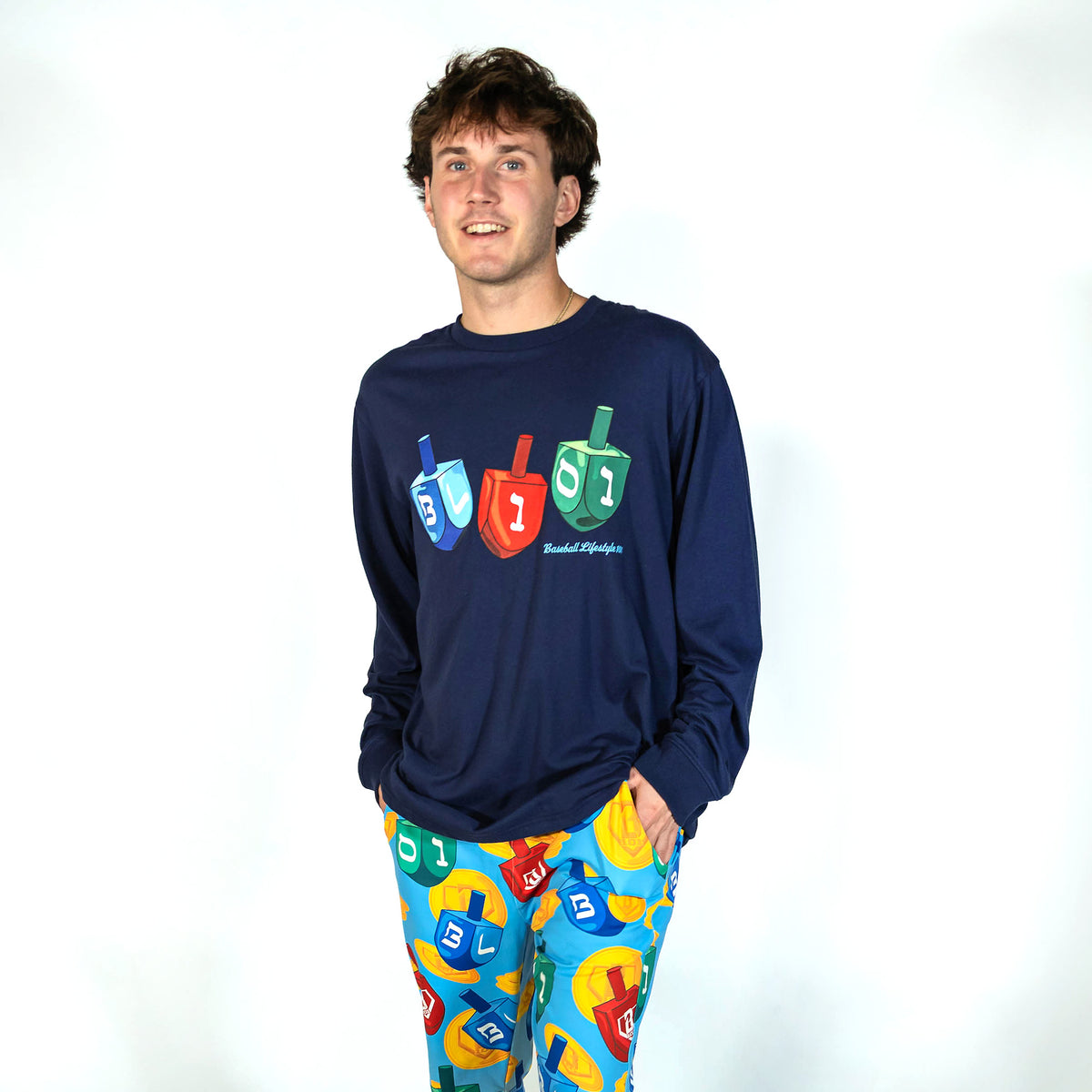 Adult model wearing navy graphic tee with "Spin & Swing Long Sleeve" design