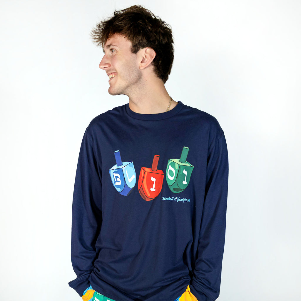 Adult model wearing navy graphic tee with "Spin & Swing Long Sleeve" design