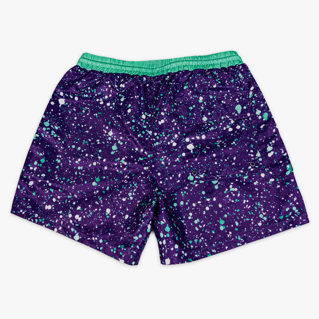 Front flat lay of BL101 purple splatter swim trunks on a white background.