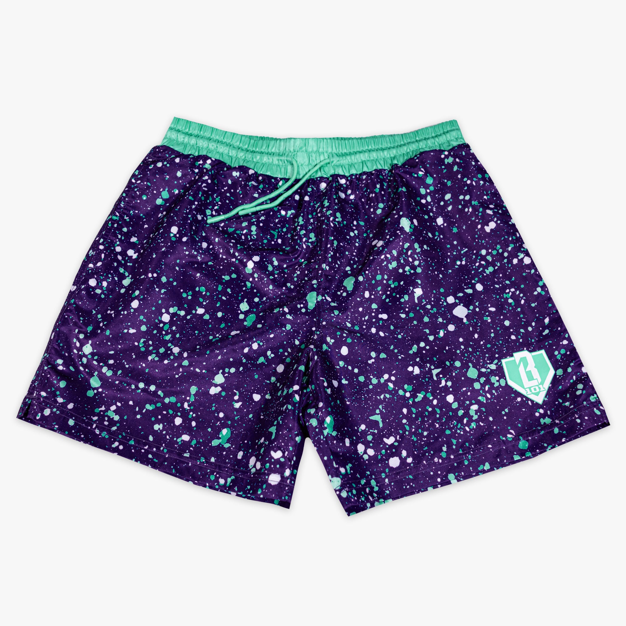 Back flat lay of BL101 purple splatter swim trunks showing the cargo pocket and teal waistband.