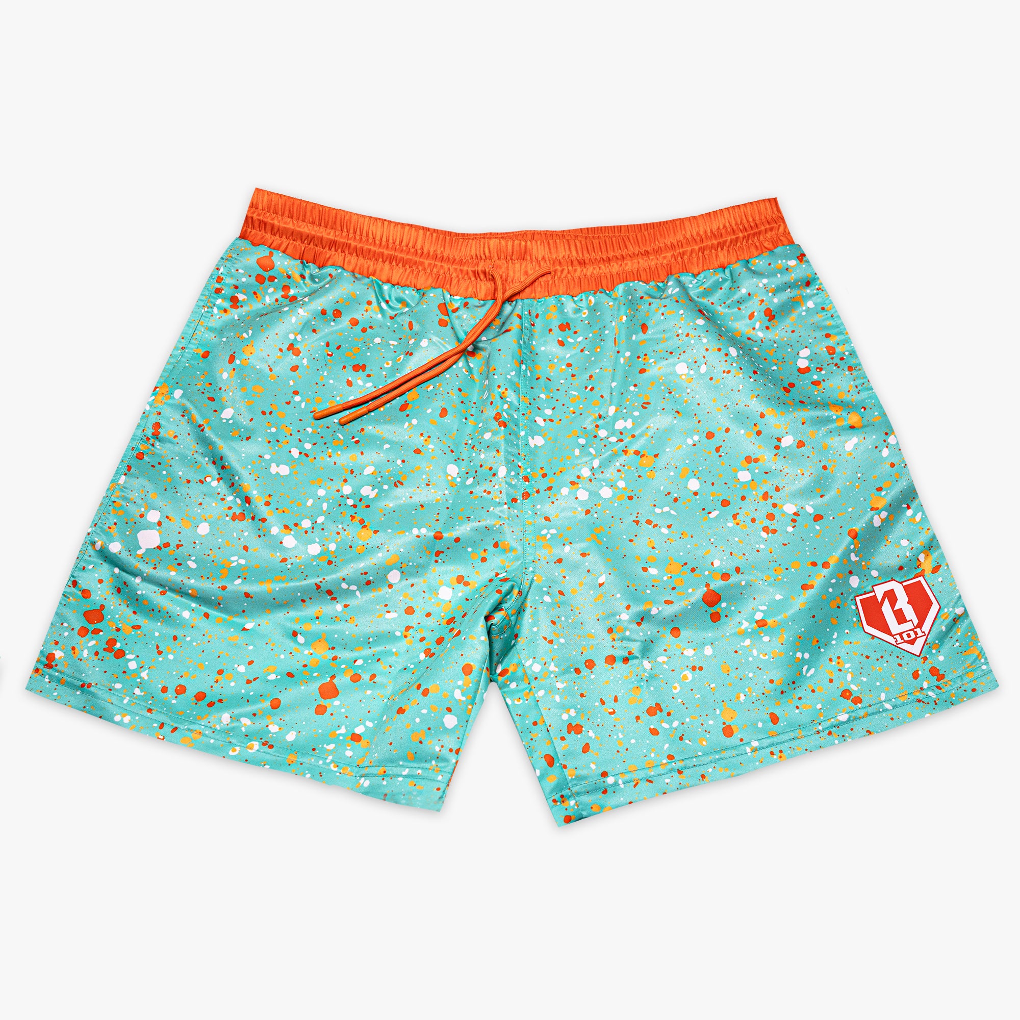 Front flat lay of BL101 teal splatter print swim trunks on a white background with orange waistband and BL101 logo on the leg.