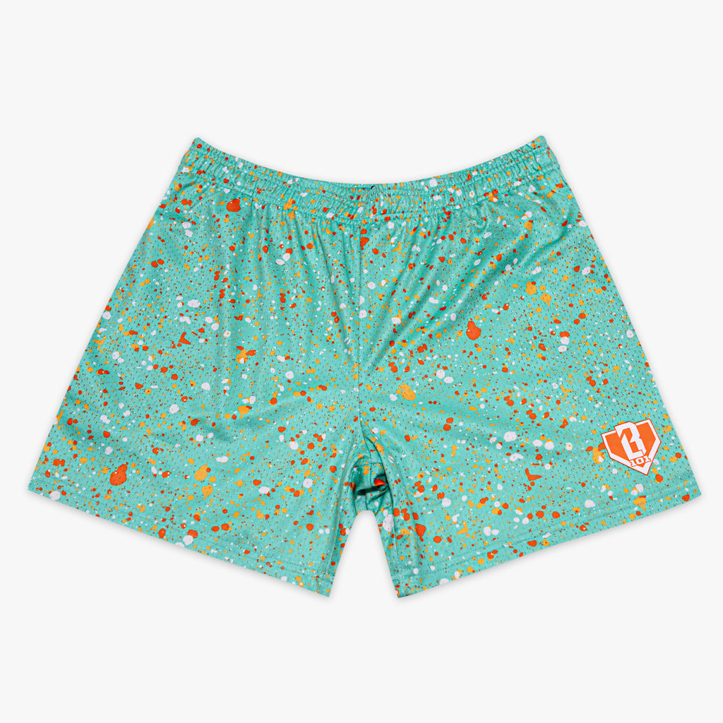 Teal shorts with orange and white specks on a white background