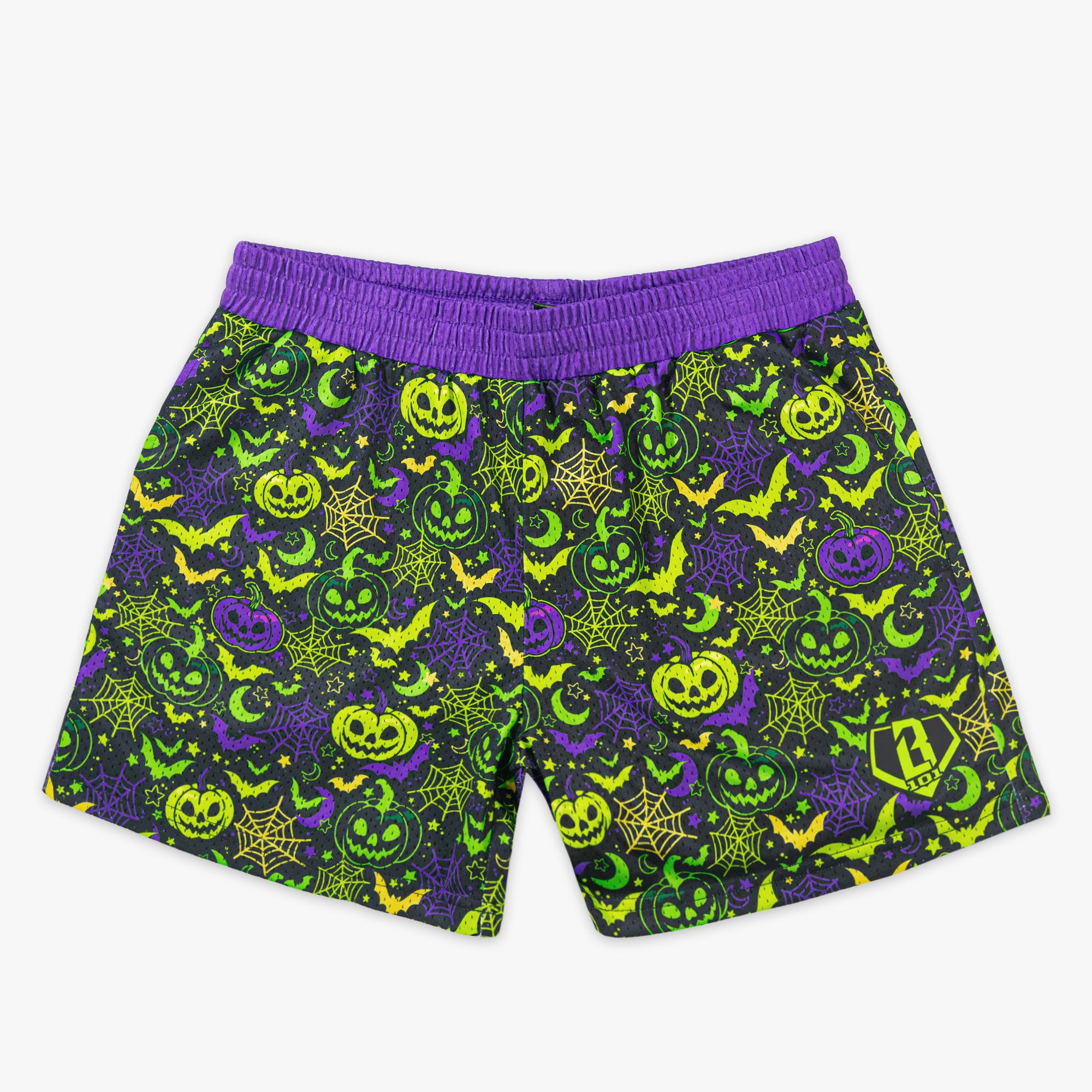 Purple and green halloween-themed shorts with pumpkins, ghosts, and bats on a white background