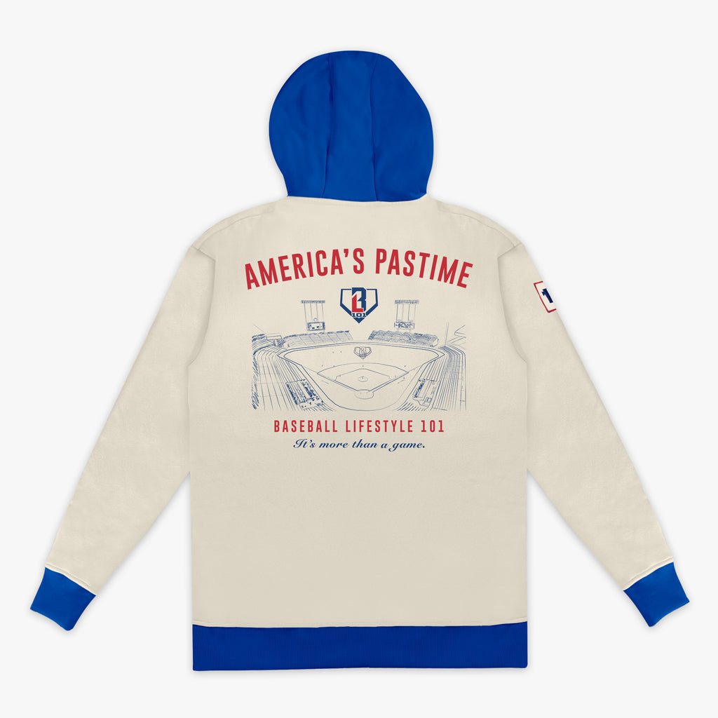 Beige hoodie with blue hood and cuffs, featuring a baseball stadium graphic and 'America's Pastime Baseball Lifestyle 101' text on the back.