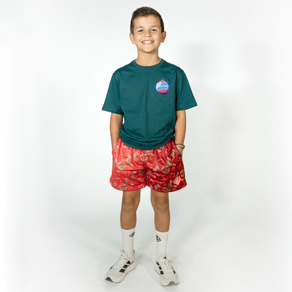 Youth model wearing red Stitched For The SZN youth shorts