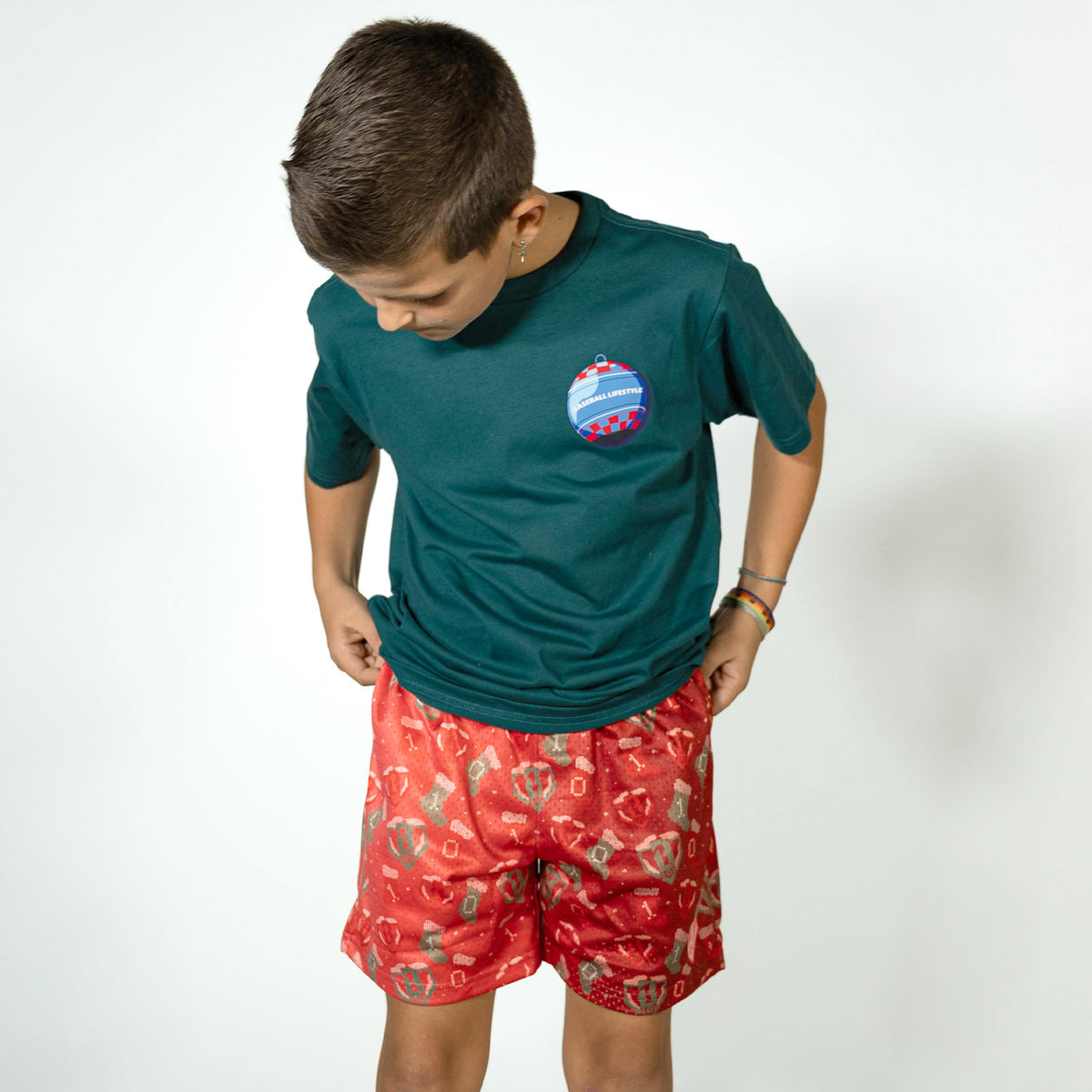 Youth model wearing red Stitched For The SZN youth shorts