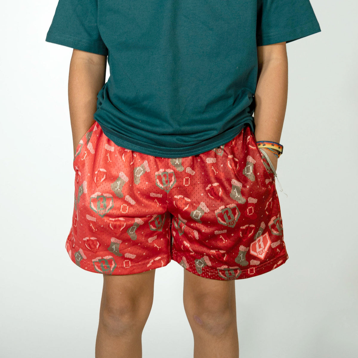 Youth model wearing red Stitched For The SZN youth shorts