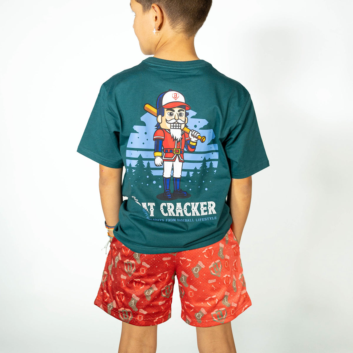 Youth model wearing red Stitched For The SZN youth shorts