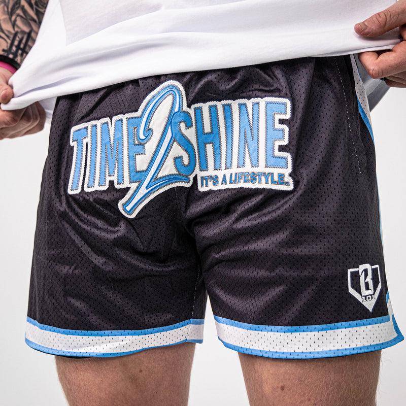 Adult model wearing shorts with "Time 2 Shine" design