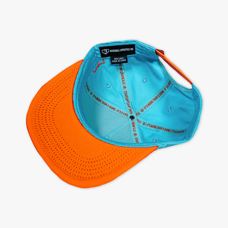 Adult model wearing blue hat with "Trash Talk" design