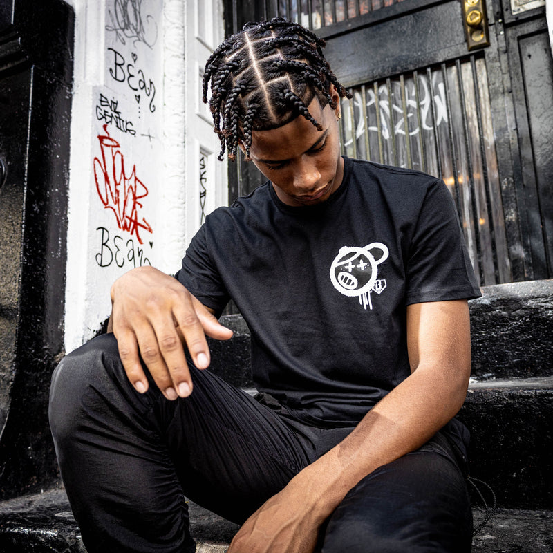 Adult model wearing black and white Vandal graphic tee