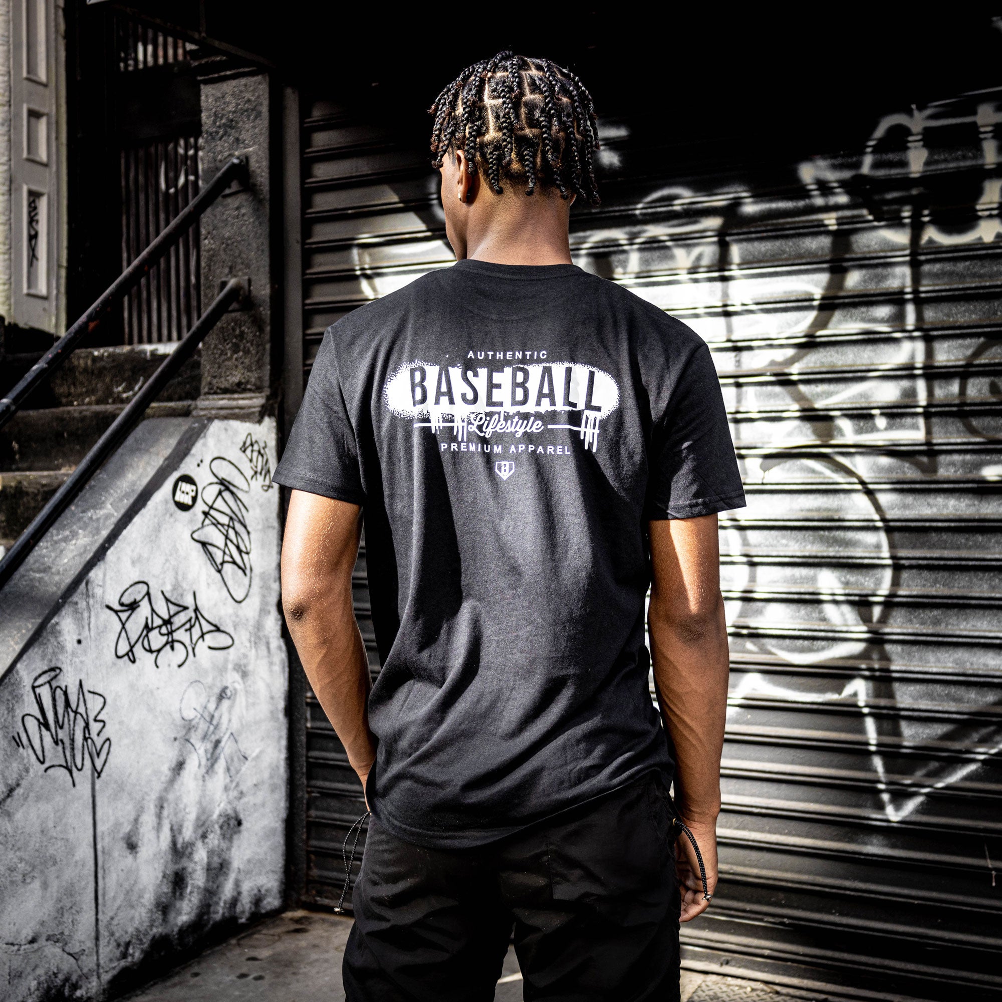 Adult model wearing black and white Vandal graphic tee