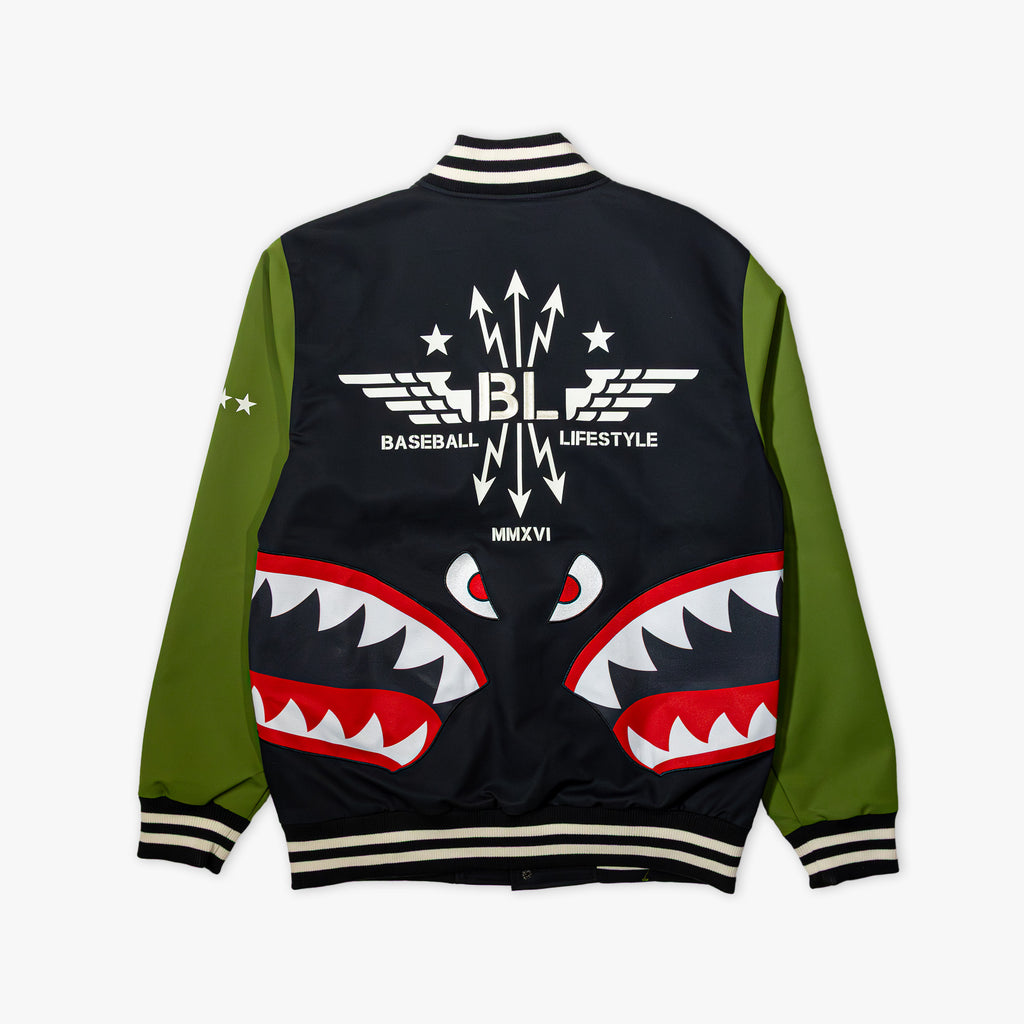 Black and green varsity jacket with white embroidered Baseball Lifestyle BL winged logo, white star graphics, and large red shark mouth design on back