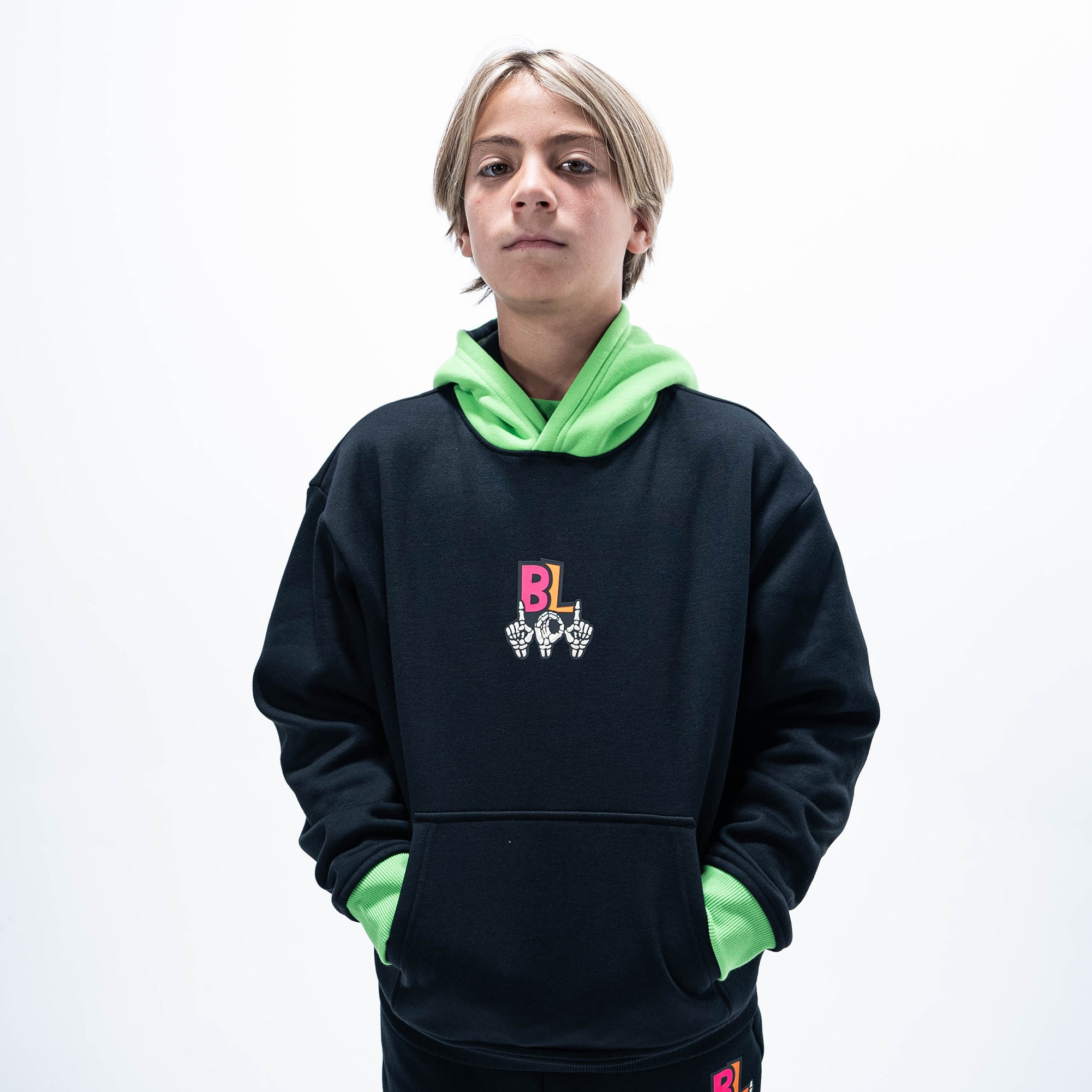 Youth model wearing black youth hoodie with "101 Skeleton" design