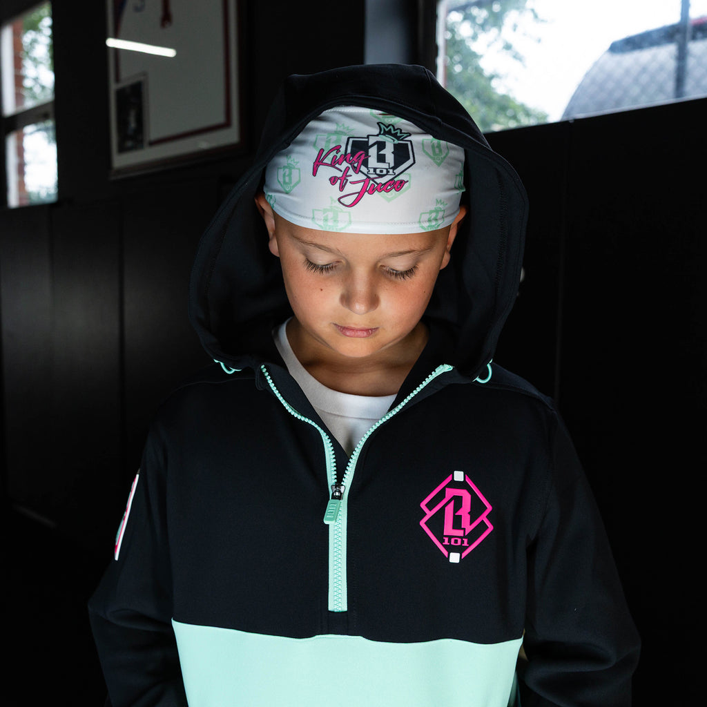 Youth model wearing white headband with "BL101 X Eric Sim" design