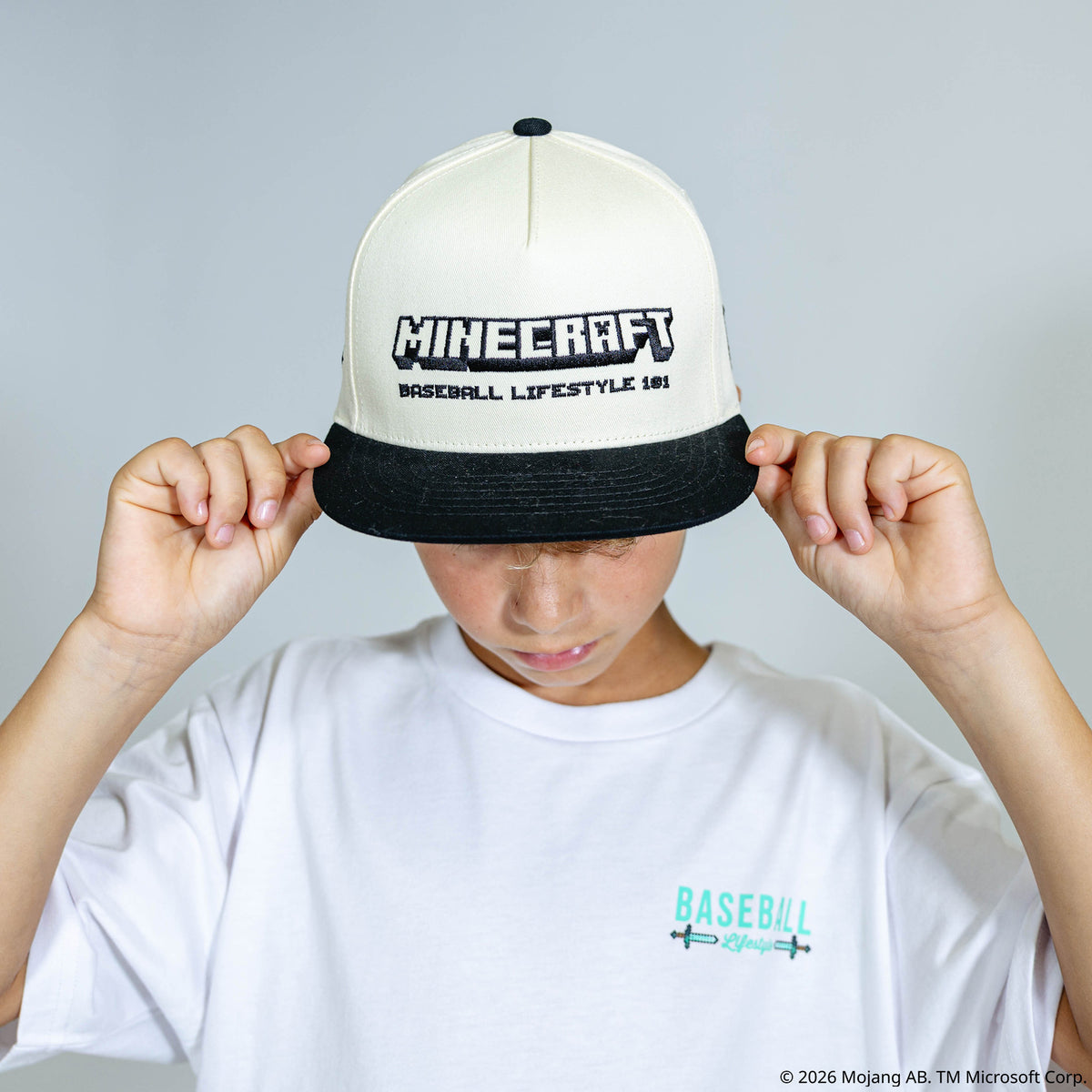 Adult model wearing black and white hat with "BL101 x Minecraft Sword" design
