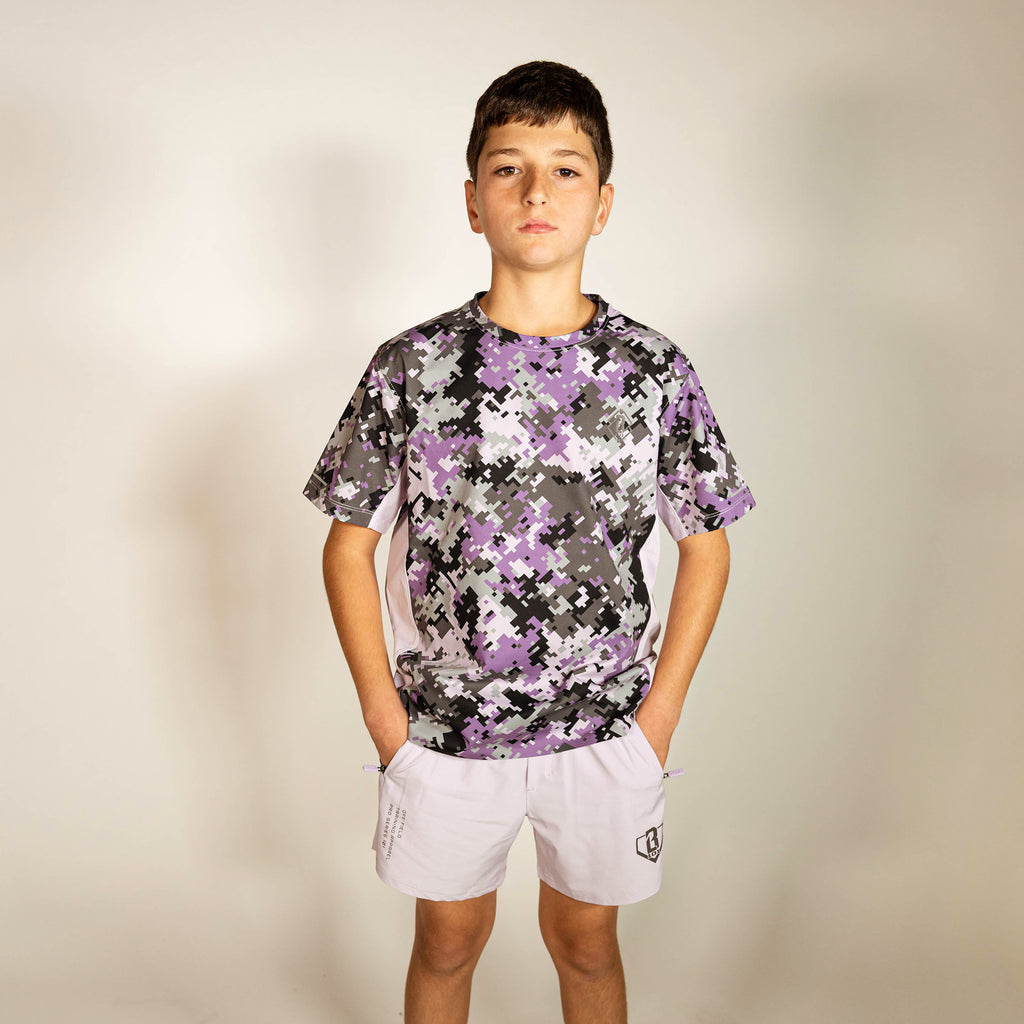 Youth model wearing multi-color Digi Camo Diamond Tech youth vented tee