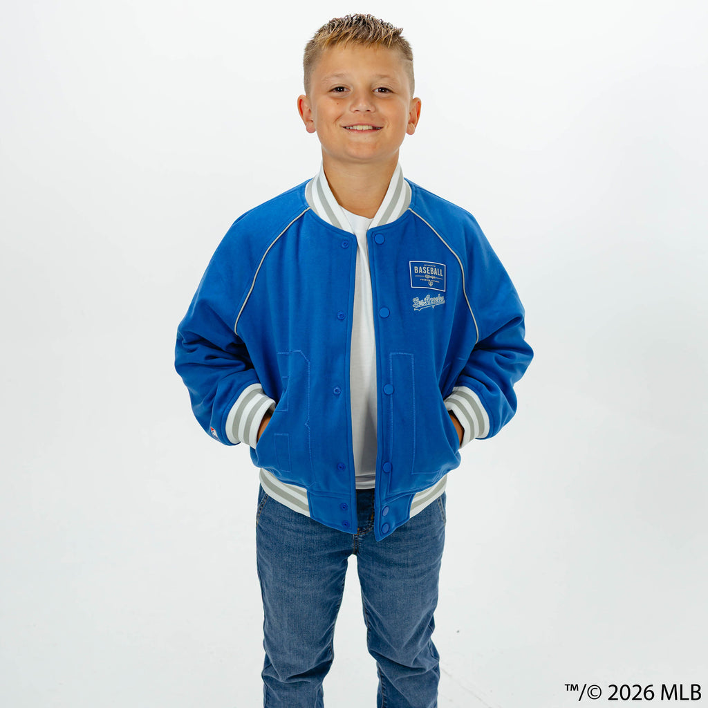 Youth model wearing blue Los Angeles Dodgers Stadium youth bomber jacket