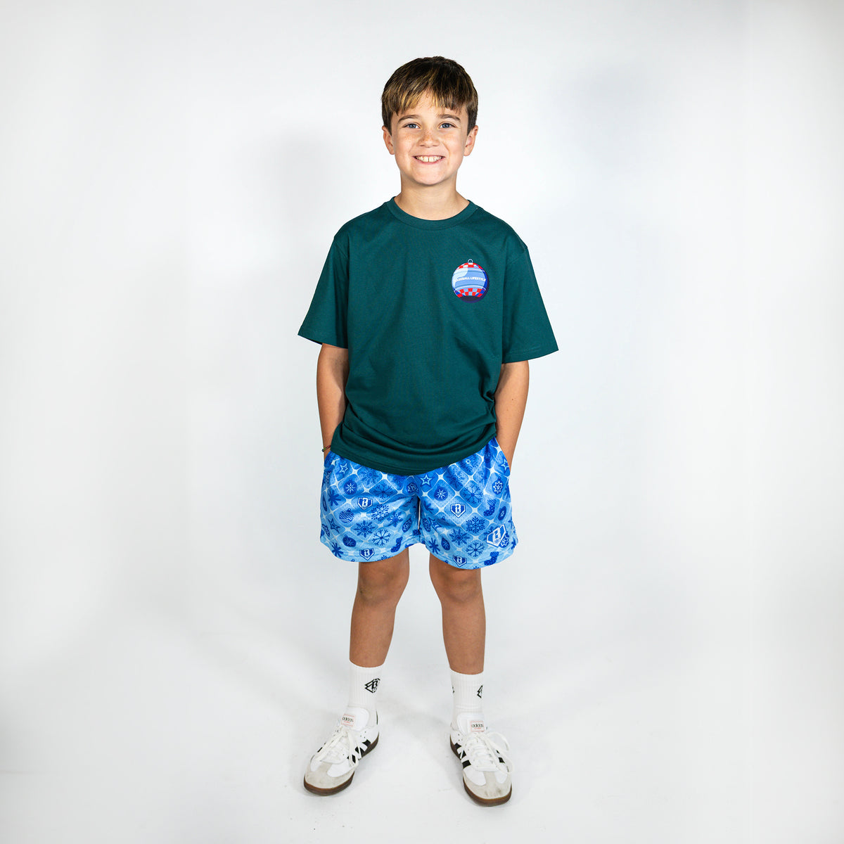 Youth model wearing blue youth shorts with "Frozen Diamond" design