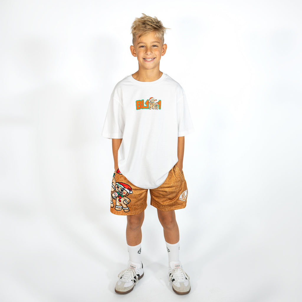 Youth model wearing brown youth shorts with "Gingerbread Rookie" design