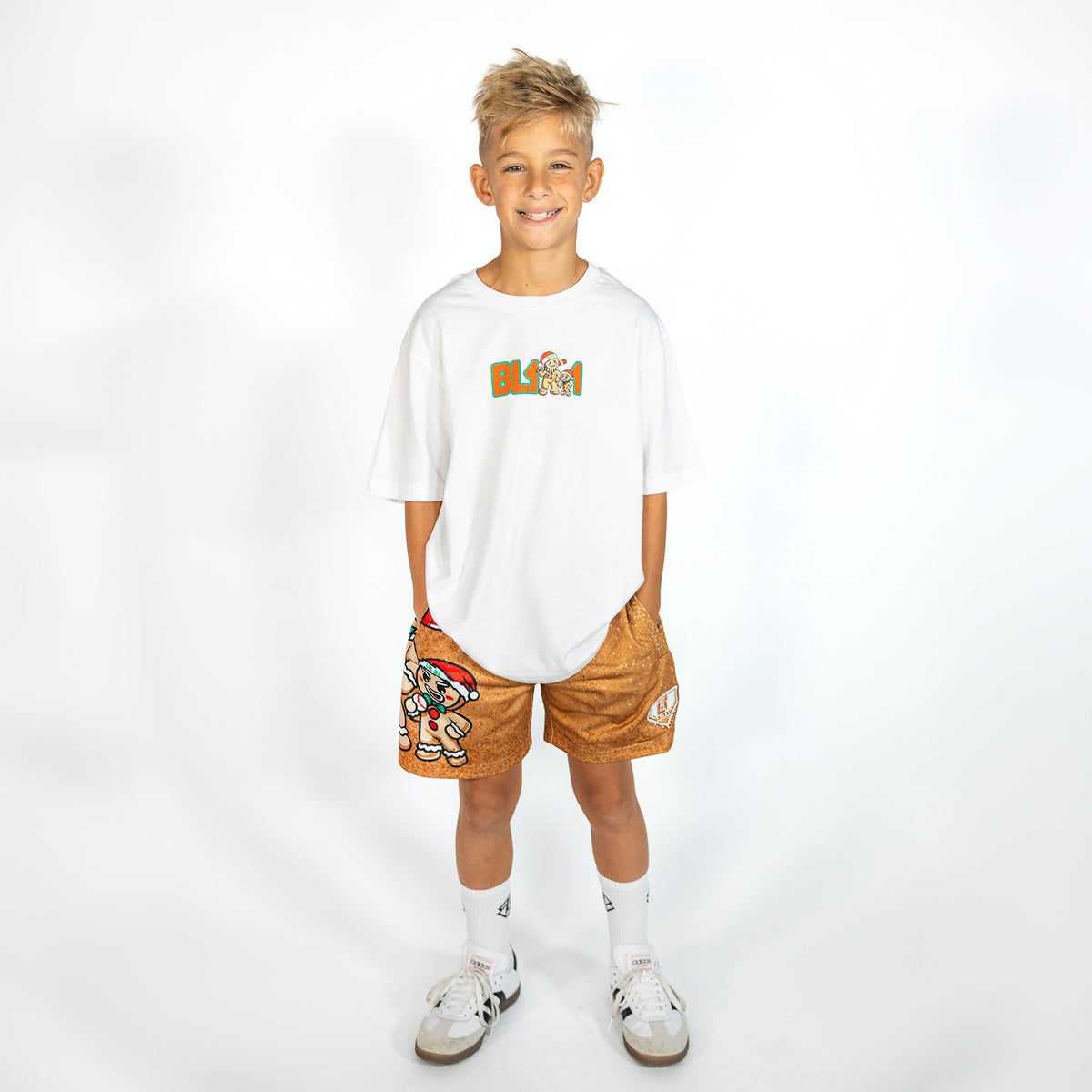 Youth model wearing brown youth shorts with "Gingerbread Rookie" design