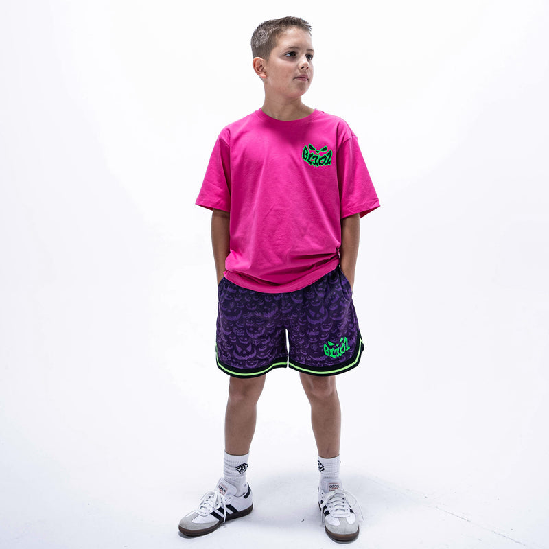 Youth model wearing purple youth shorts with "Jack O' Lantern Team" design