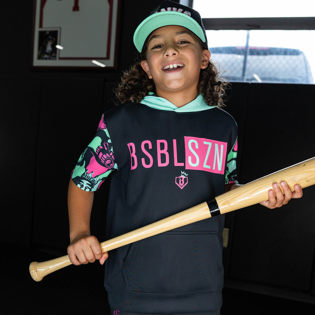 Youth model wearing black short sleeve hoodie with "King Of JUCO BSBL-SZN V3" design