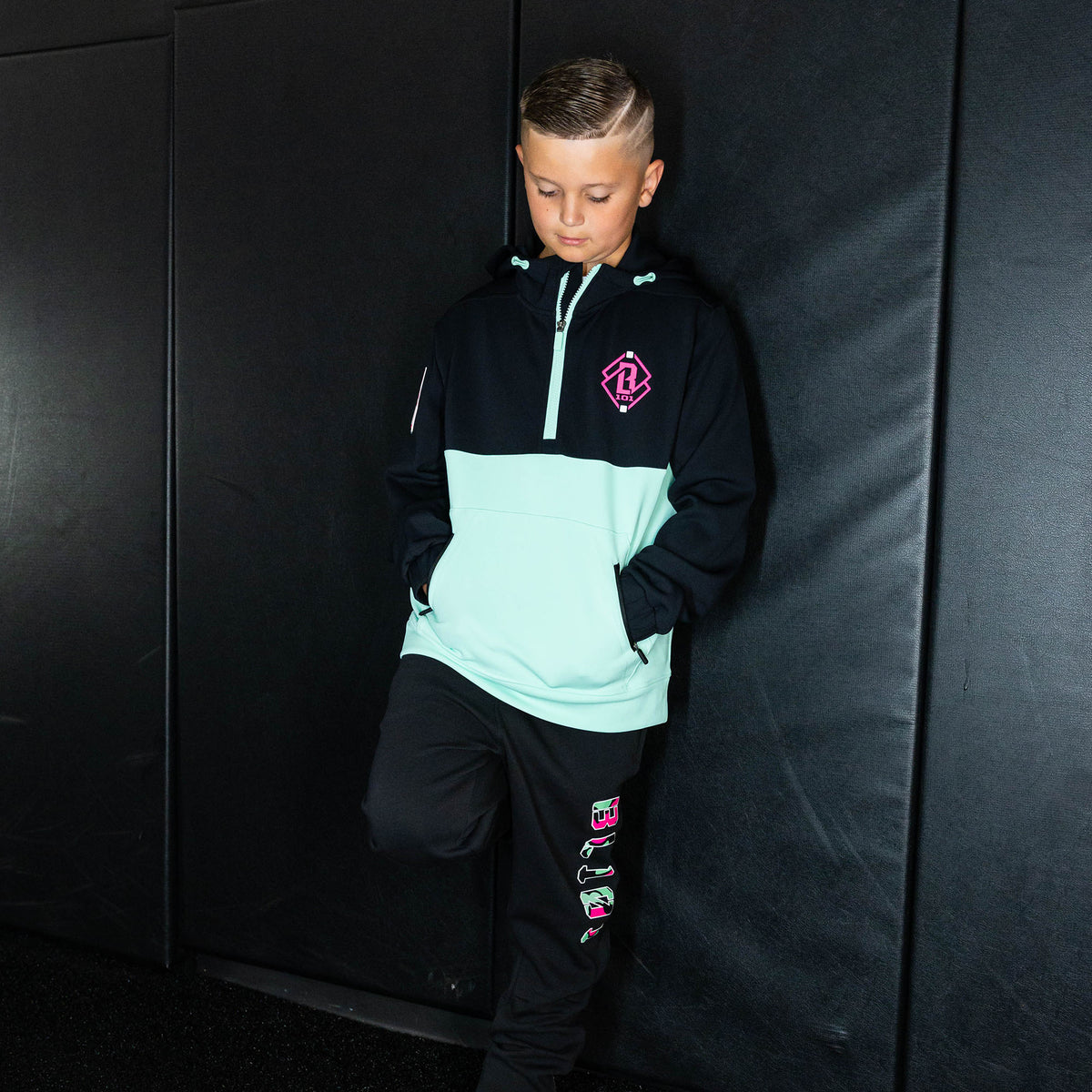 Youth model wearing black relaxed fit joggers with "King Of JUCO Diamond" design