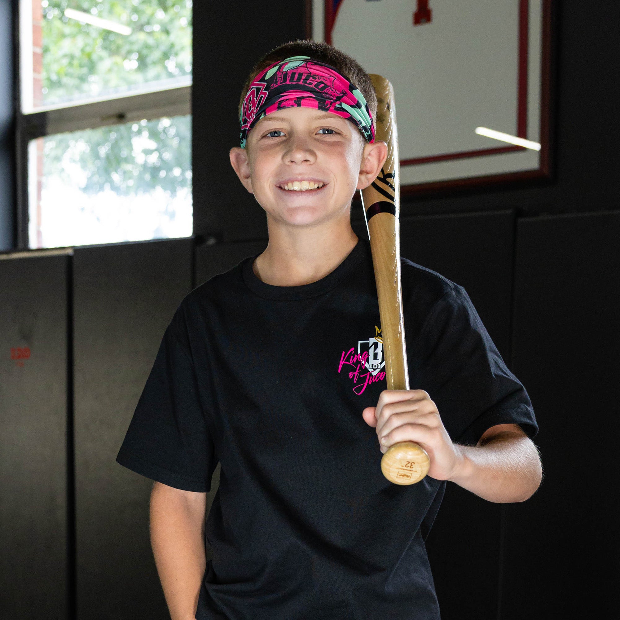 Youth model wearing black headband with "King of JUCO" design