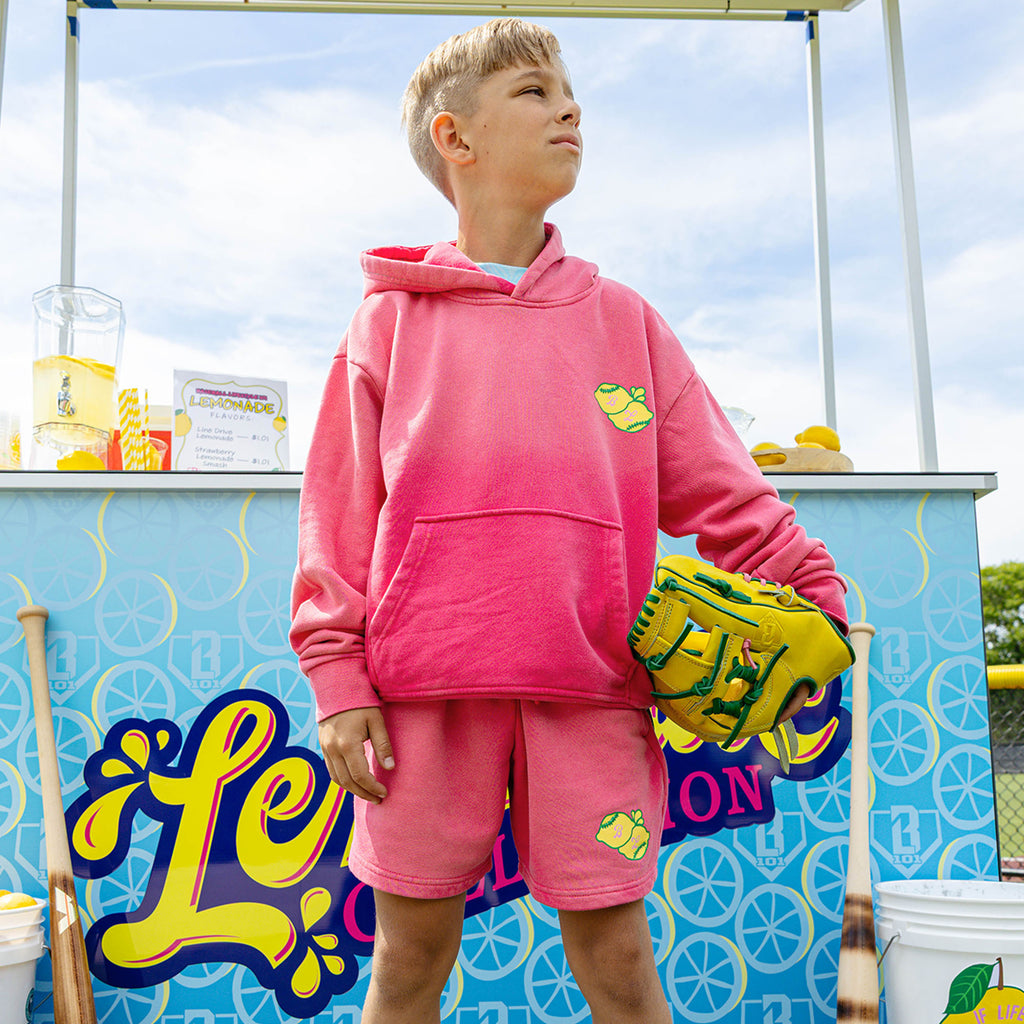 Youth model wearing pink youth hoodie with "Lemon Dingers" design