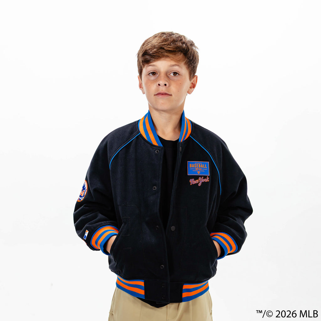 Youth model wearing black New York Mets Stadium youth bomber jacket